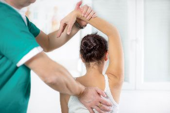 Woman receiving treatment for shoulder pain